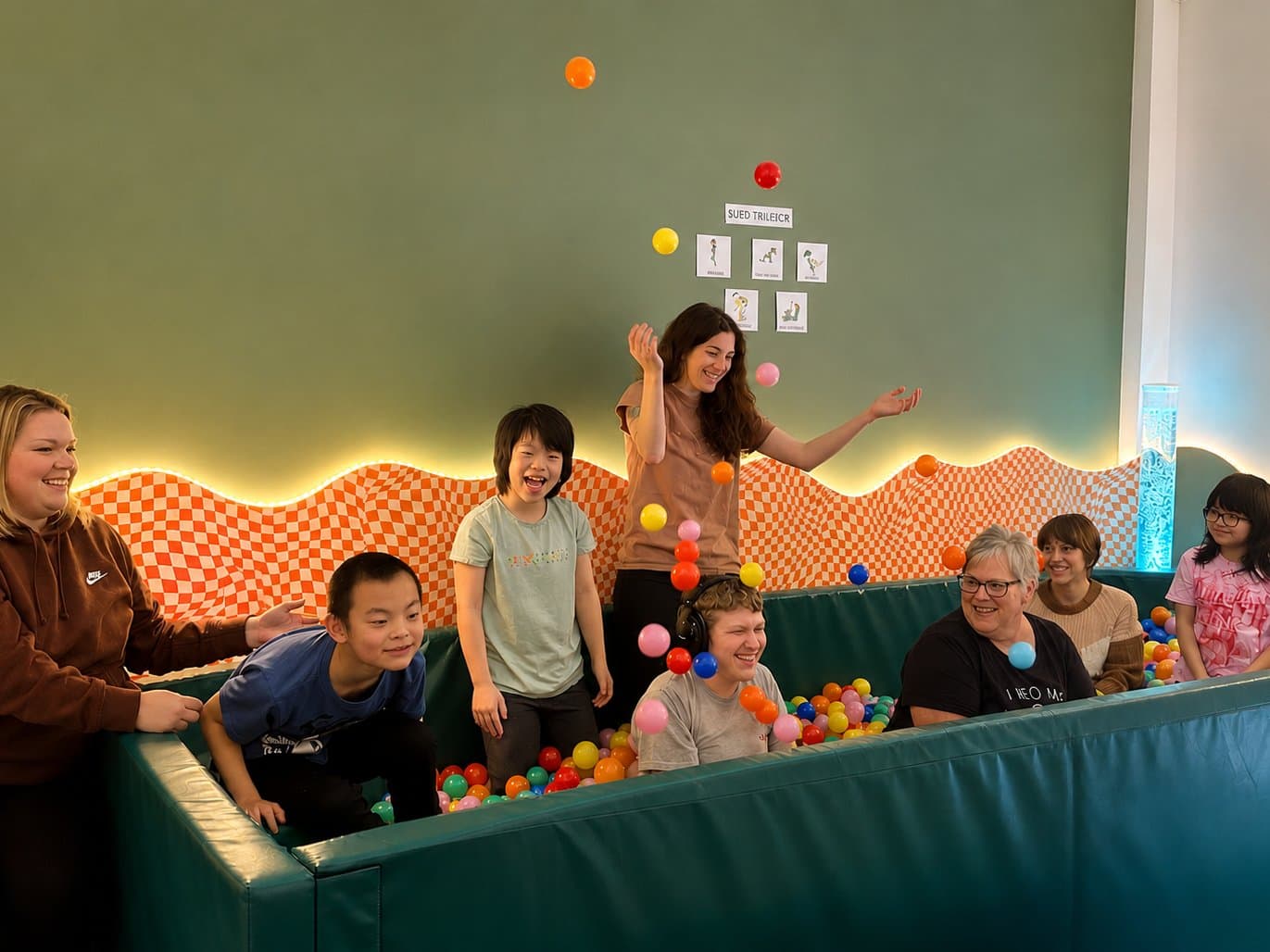 Children and Strides staff together in the sensory play space